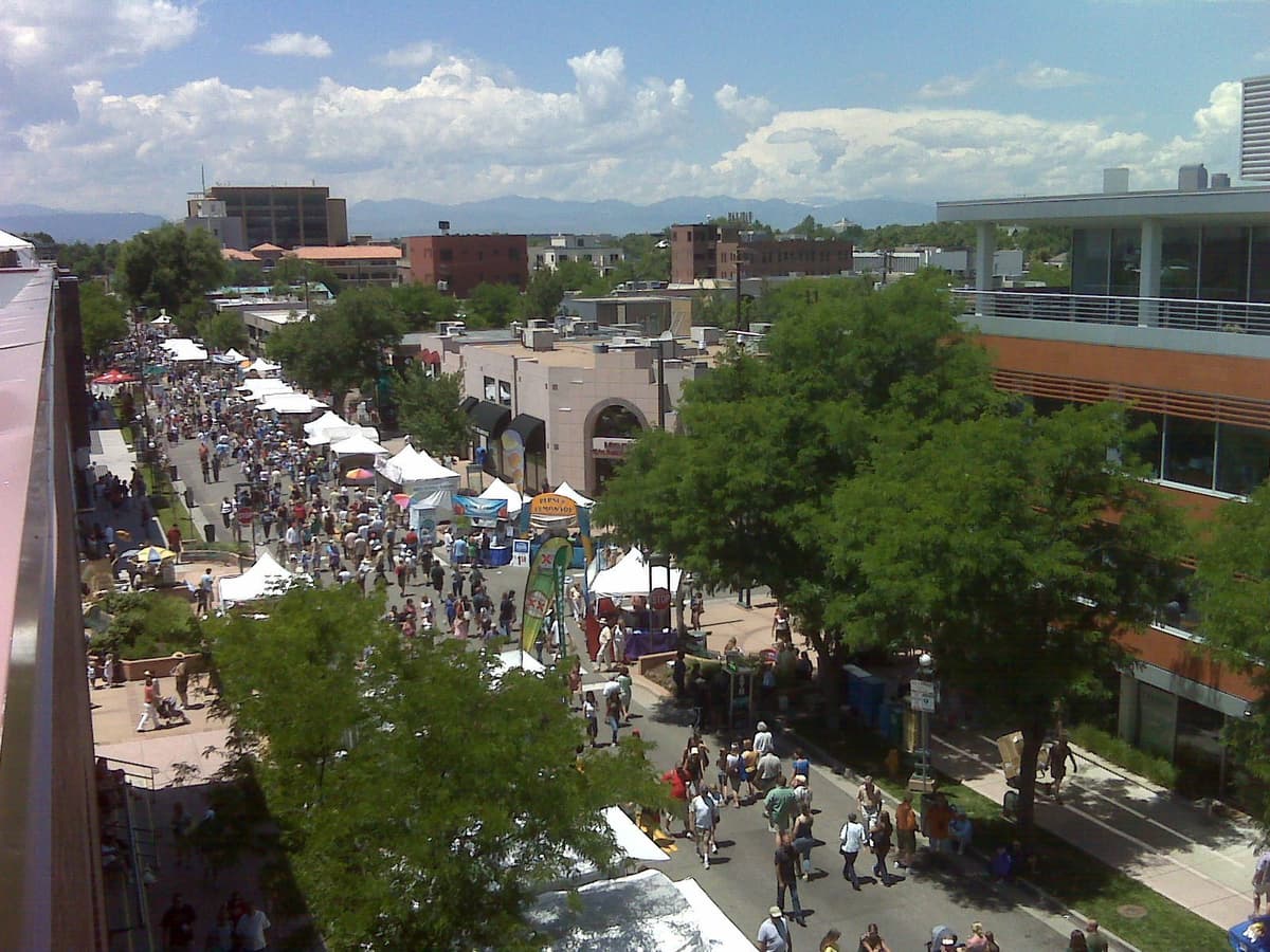 The Cherry Creek Arts Festival filling the streets of the Cherry Creek North shopping district, with the mountains beyond