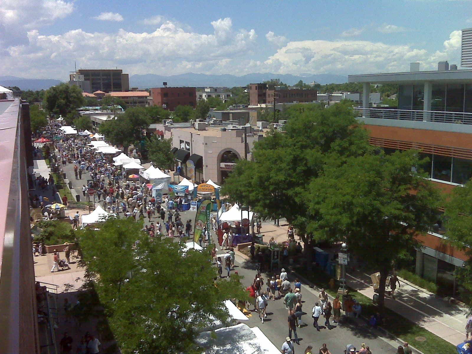 The Cherry Creek Arts Festival filling the streets of the Cherry Creek North shopping district, with the mountains beyond