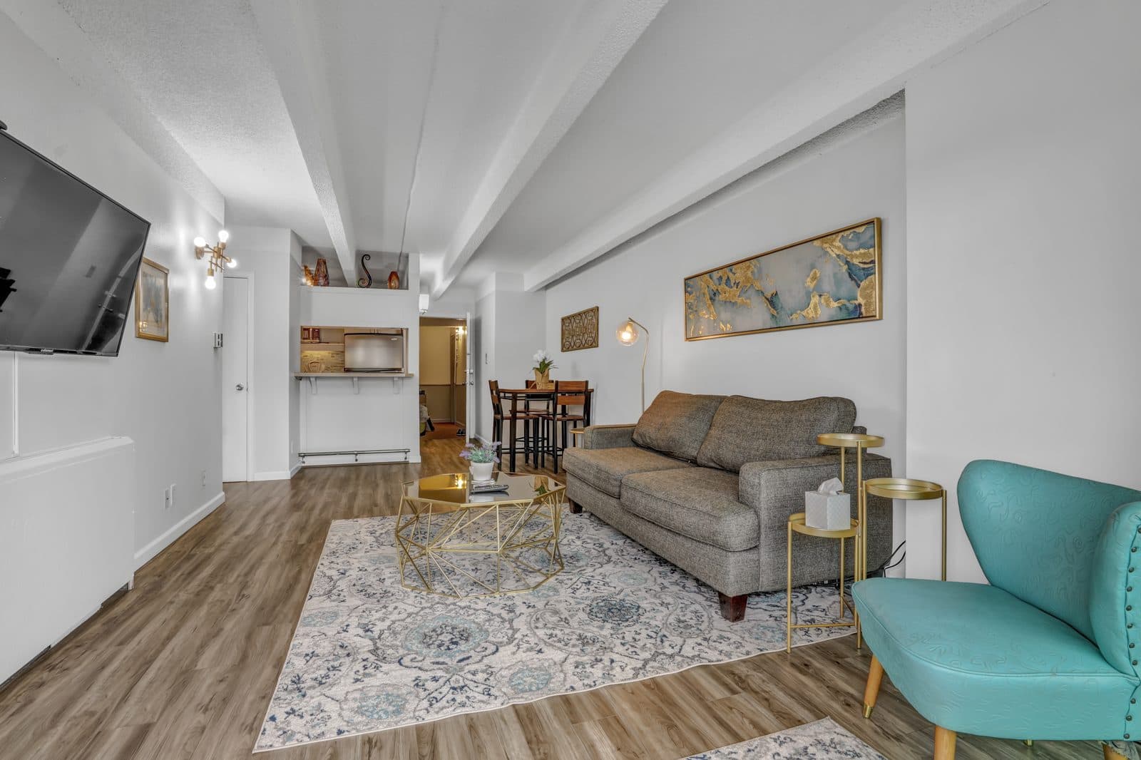 Living room with the kitchen pass-through and dining area visible in the background